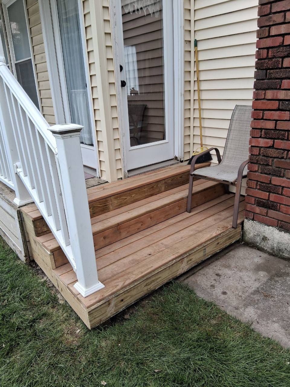 A freshly rebuilt wooden porch and steps