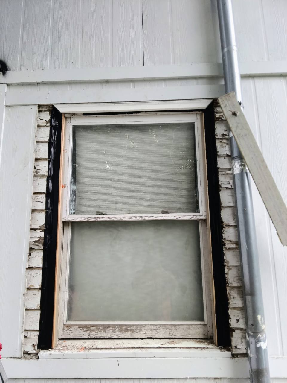 Black weatherproofing membrane installed around the exterior window opening